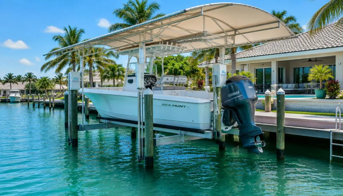 Center console boat on a covered boat lift behind a Florida waterfront home