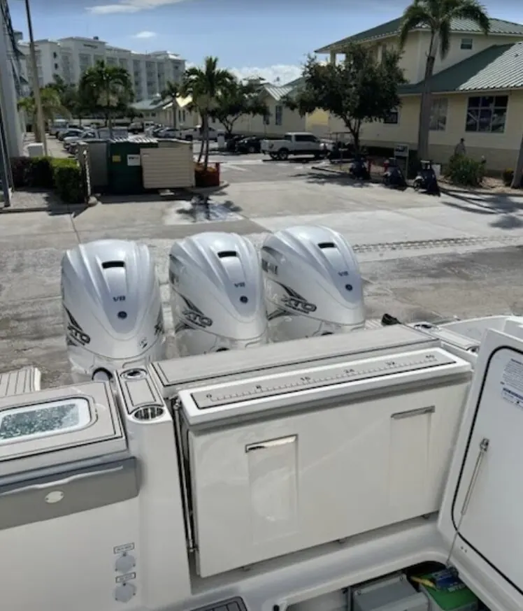 Triple outboard engines on a center console at a marina